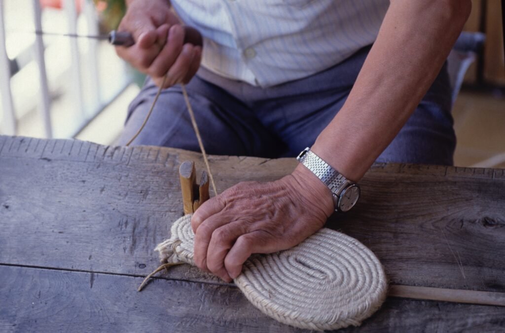 Manos del Sr. Alfonso, cosiendo las suelas. Proceso clave para la fabricación de una alpargata. Hecho a mano en Barcelona.